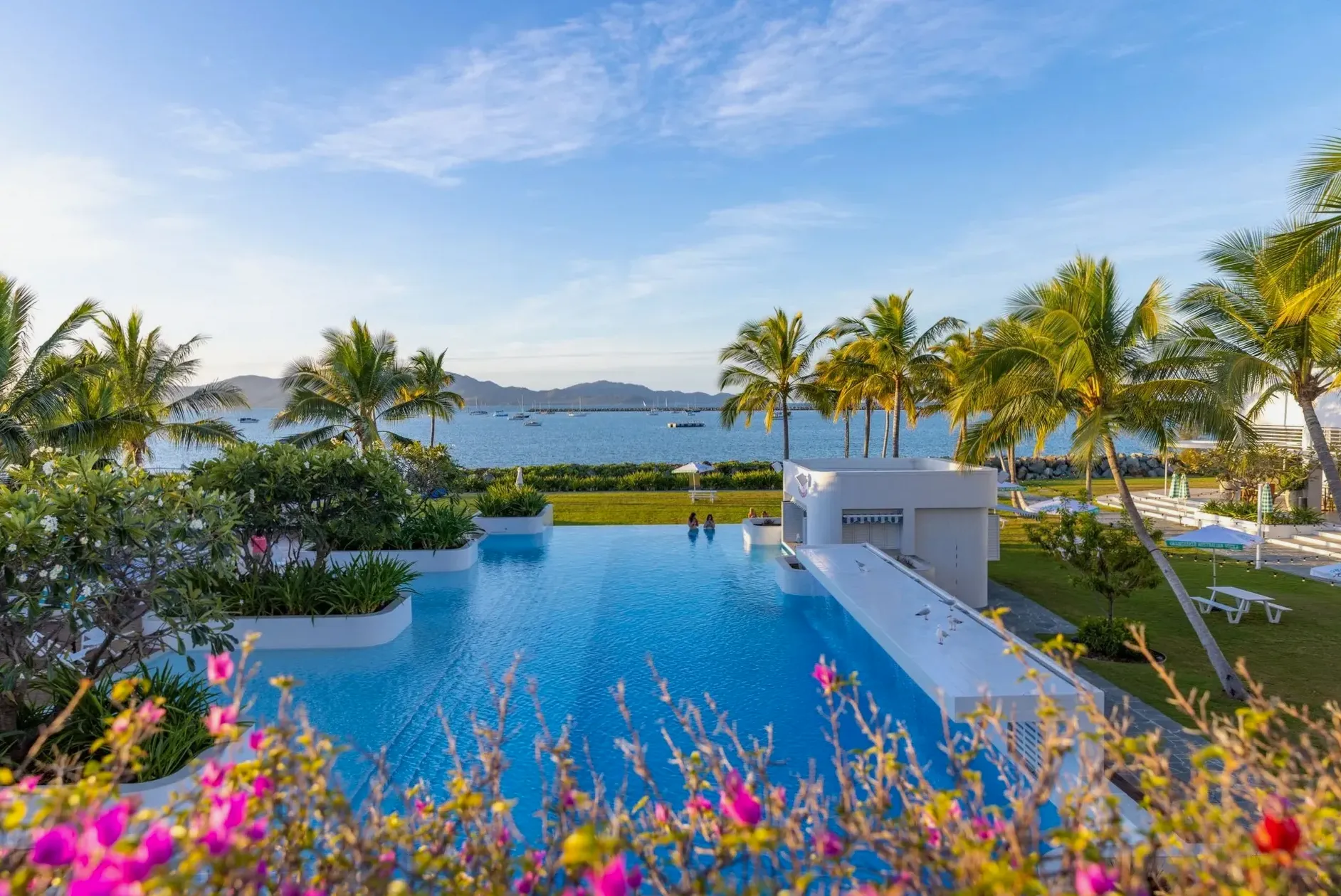 Infinity-edge pool at The Ville Resort overlooking the Coral Sea toward Magnetic Island, Townsville, North Queensland